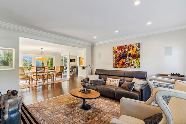 living room featuring wood-type flooring and ornamental molding