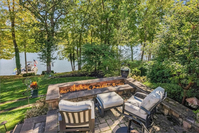 view of patio featuring a water view and an outdoor fire pit