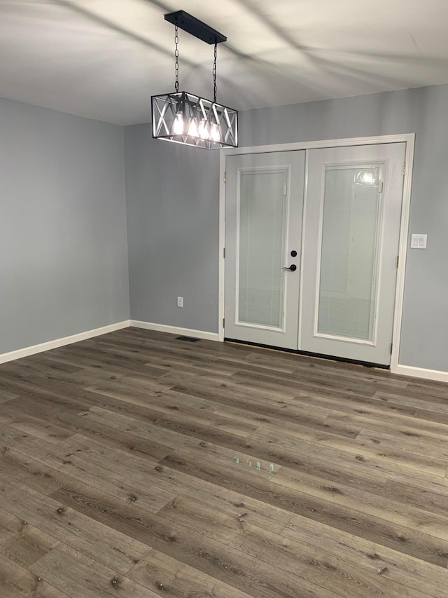 empty room with french doors and dark hardwood / wood-style floors