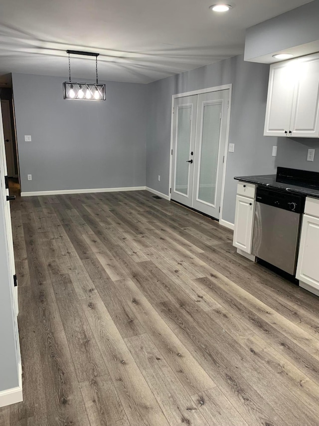 interior space featuring dishwasher, pendant lighting, light hardwood / wood-style flooring, and white cabinetry