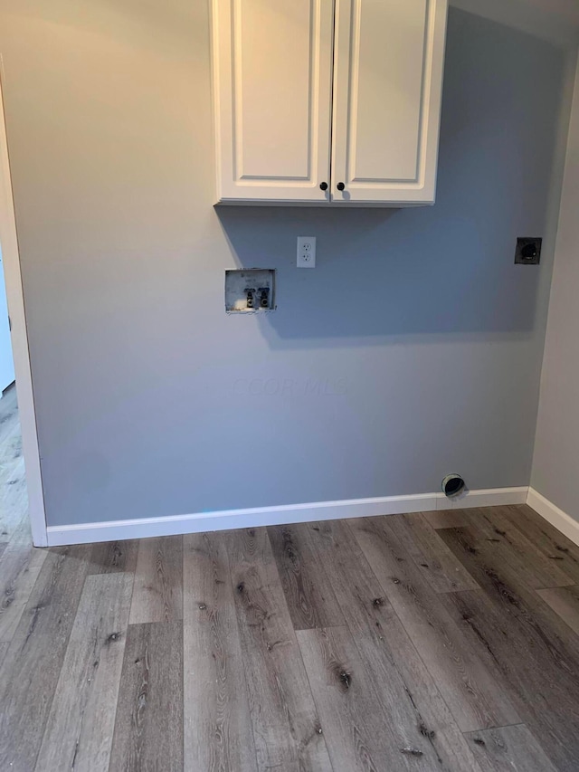 washroom featuring hookup for an electric dryer, cabinets, hookup for a washing machine, and light hardwood / wood-style flooring