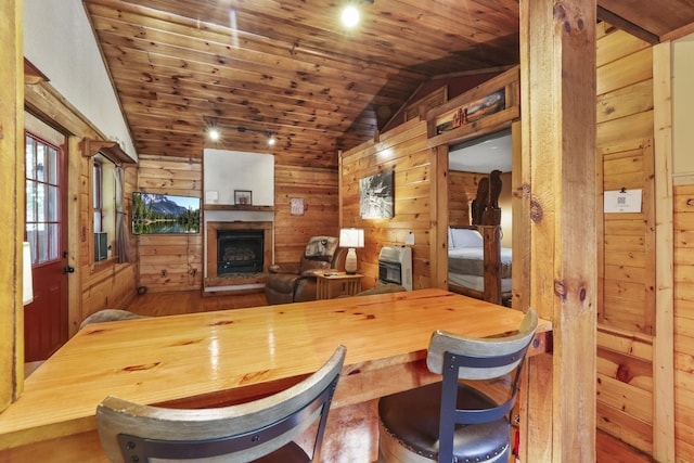 interior space with wooden ceiling, wooden counters, wooden walls, vaulted ceiling, and hardwood / wood-style flooring