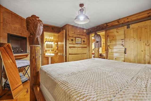 bedroom with wood walls and wood-type flooring