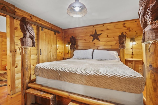 bedroom featuring hardwood / wood-style floors and wooden walls