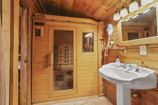 bathroom featuring wood walls, wood ceiling, and lofted ceiling