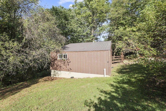 view of outbuilding featuring a lawn