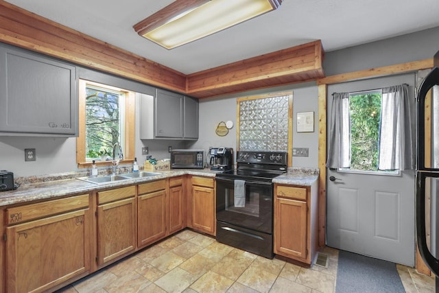 kitchen featuring sink and black range with electric cooktop