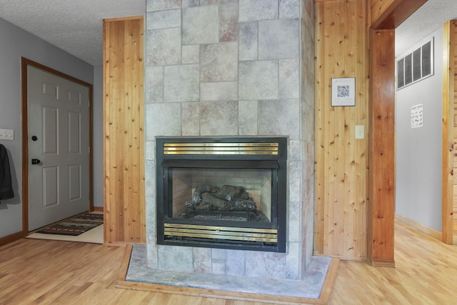 room details featuring a tiled fireplace and hardwood / wood-style floors