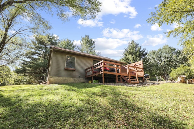 back of property featuring a lawn and a wooden deck