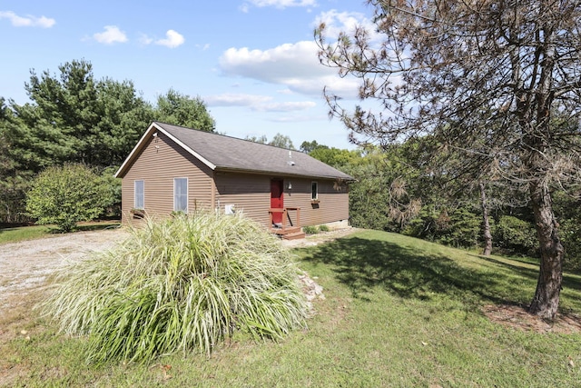 view of property exterior with a lawn