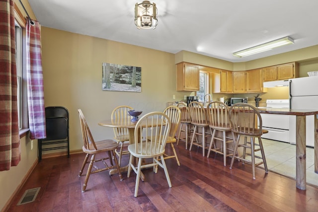 dining area with dark hardwood / wood-style floors