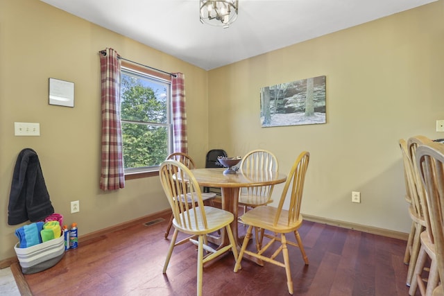 dining room with dark hardwood / wood-style flooring