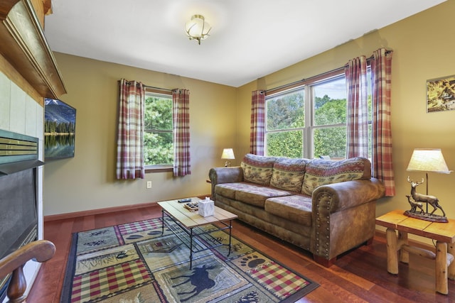 living room with plenty of natural light and dark hardwood / wood-style floors