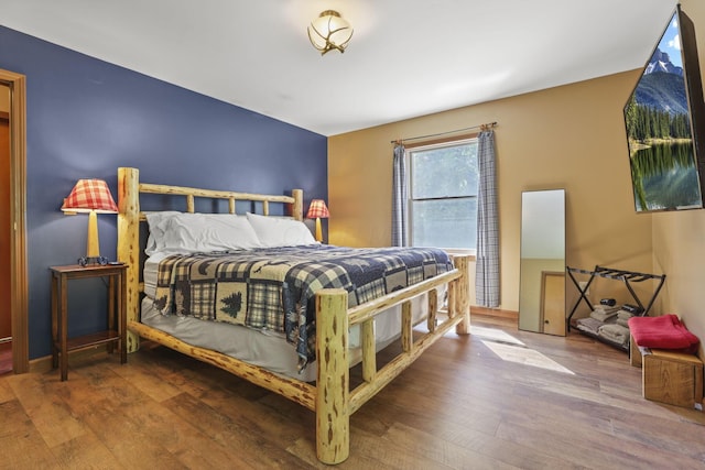 bedroom with hardwood / wood-style flooring