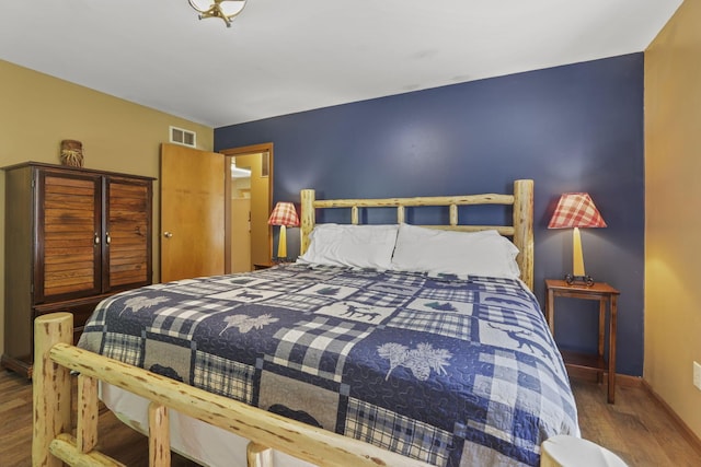 bedroom with hardwood / wood-style floors