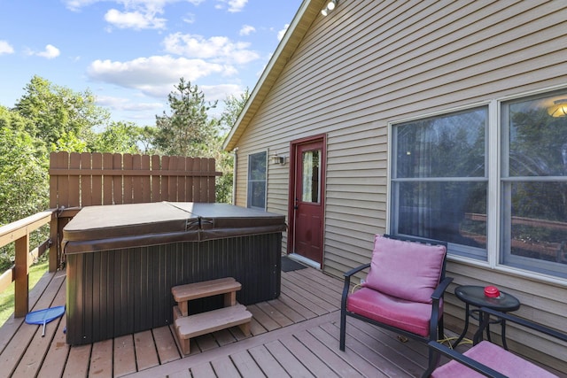 wooden deck with a hot tub