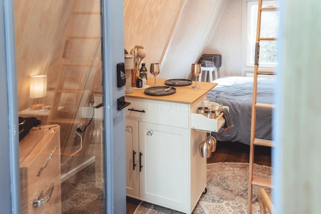 bedroom with crown molding and dark wood-type flooring