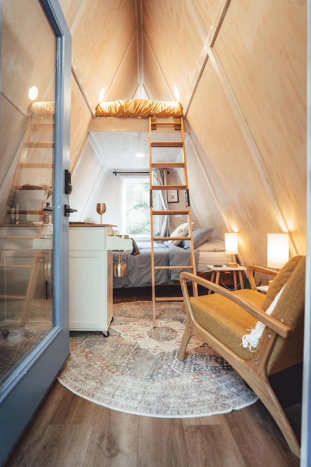 bedroom with wood-type flooring and vaulted ceiling