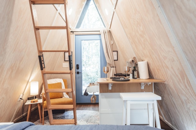 interior space featuring wood-type flooring and vaulted ceiling