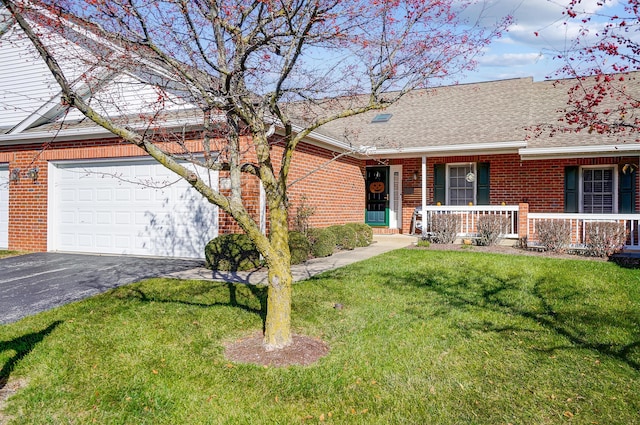 single story home featuring a porch, a garage, and a front lawn