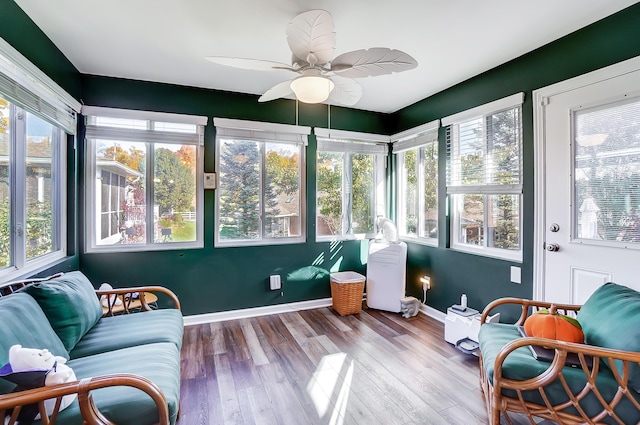 sunroom / solarium featuring a wealth of natural light and ceiling fan