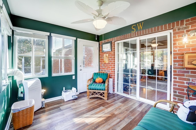 sunroom / solarium with a wealth of natural light and ceiling fan