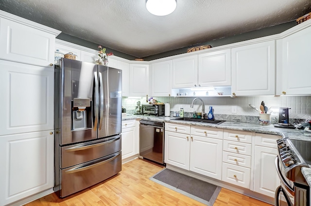 kitchen featuring white cabinets, light wood-type flooring, sink, and appliances with stainless steel finishes