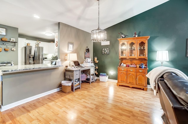 dining space with an inviting chandelier and light wood-type flooring