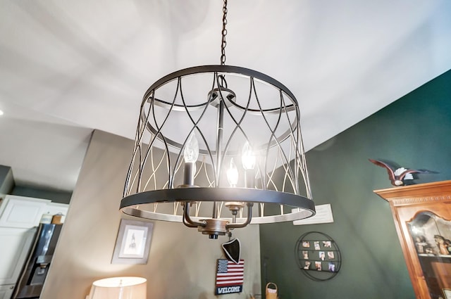 details featuring stainless steel fridge and a chandelier