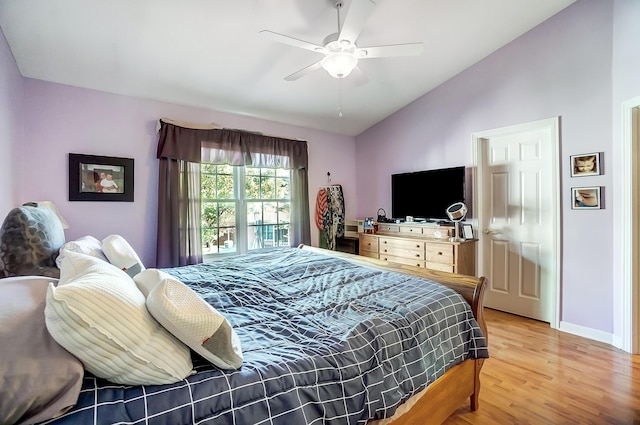 bedroom featuring ceiling fan, hardwood / wood-style floors, and vaulted ceiling