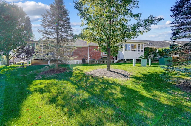 view of yard with a sunroom