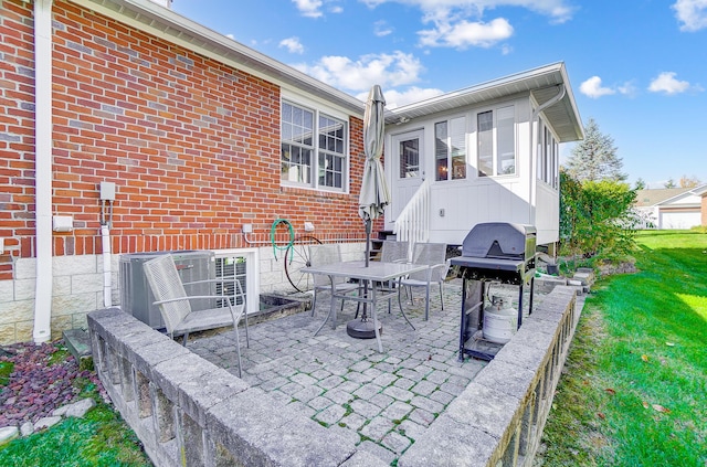 back of house with a lawn, a patio area, and cooling unit