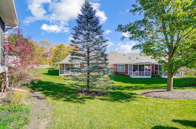 view of yard with a sunroom