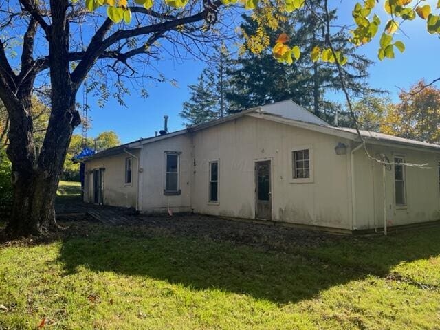 rear view of property with a yard