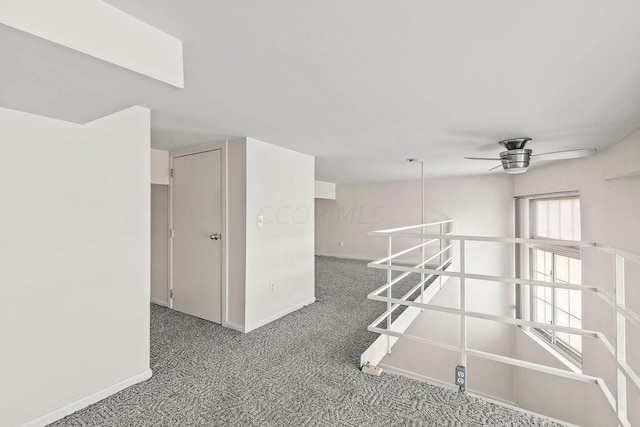 carpeted empty room featuring ceiling fan