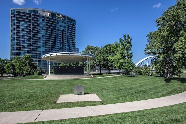 view of property's community featuring a yard and a patio area