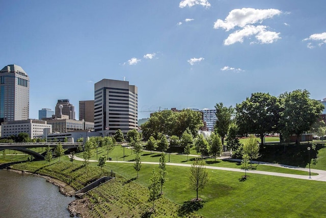 view of property's community with a yard and a water view