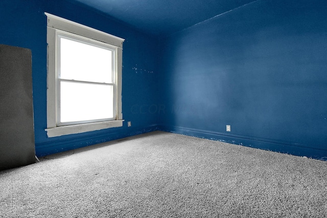 carpeted spare room featuring plenty of natural light