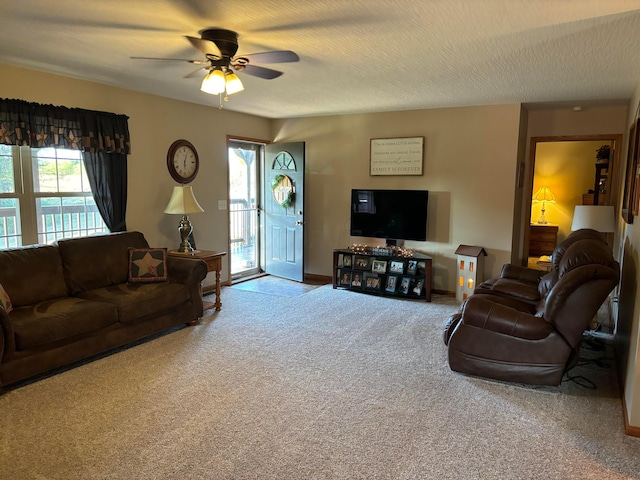 carpeted living room with a textured ceiling and ceiling fan