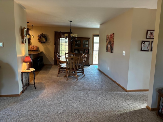 carpeted dining space with an inviting chandelier