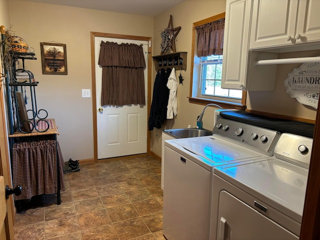 clothes washing area featuring cabinets, separate washer and dryer, and sink