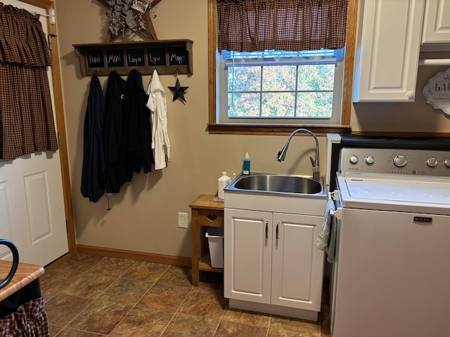 laundry area with cabinets, washer / clothes dryer, and sink