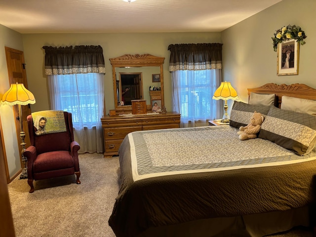 carpeted bedroom featuring multiple windows