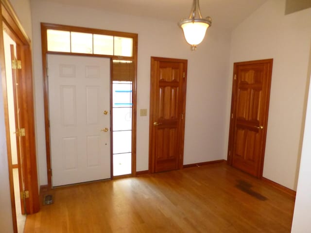 foyer entrance with light hardwood / wood-style floors