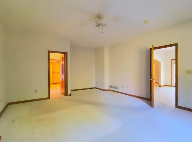 unfurnished room featuring ceiling fan and light carpet