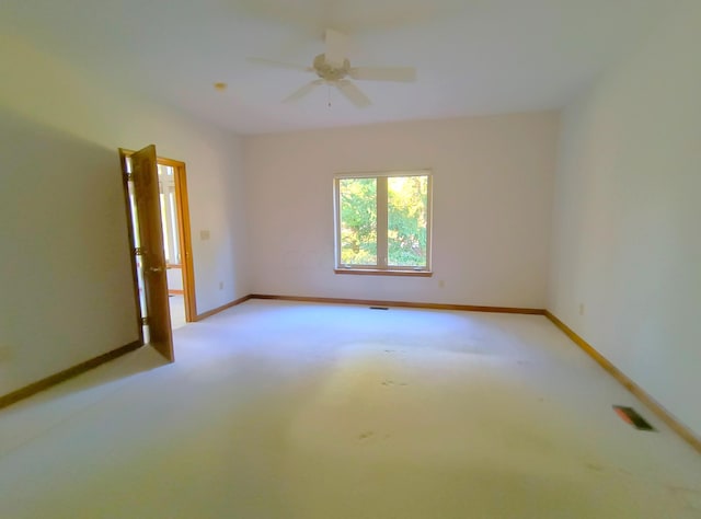 carpeted empty room featuring ceiling fan