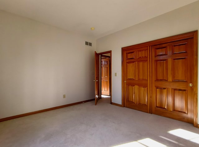 unfurnished bedroom featuring light colored carpet