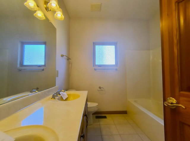 bathroom with tile patterned flooring, vanity, and toilet