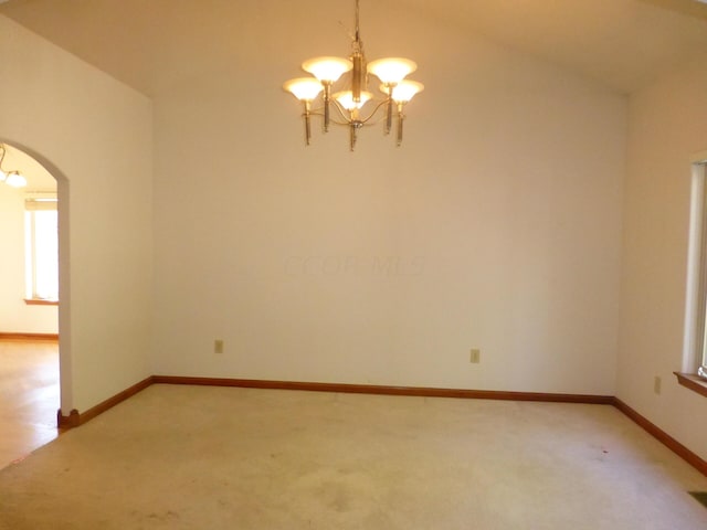 unfurnished room featuring carpet floors, lofted ceiling, and a notable chandelier