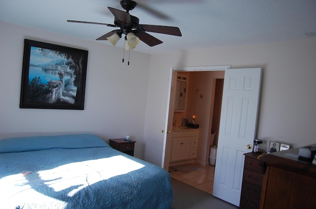 tiled bedroom with ceiling fan and ensuite bathroom